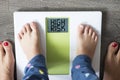 Childhood obesity high risk for health problems with childâs feet on weight scale under the supervision of his mother